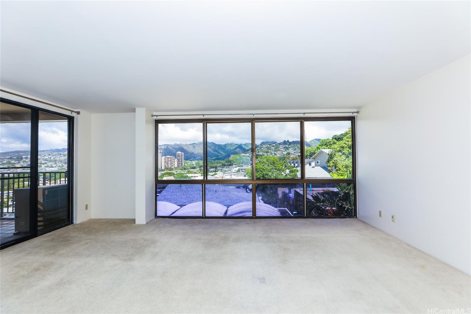217 Prospect Street, Unit 101 Honolulu, HI 96813 - Photo 5 of 25 an empty room with large windows and couch