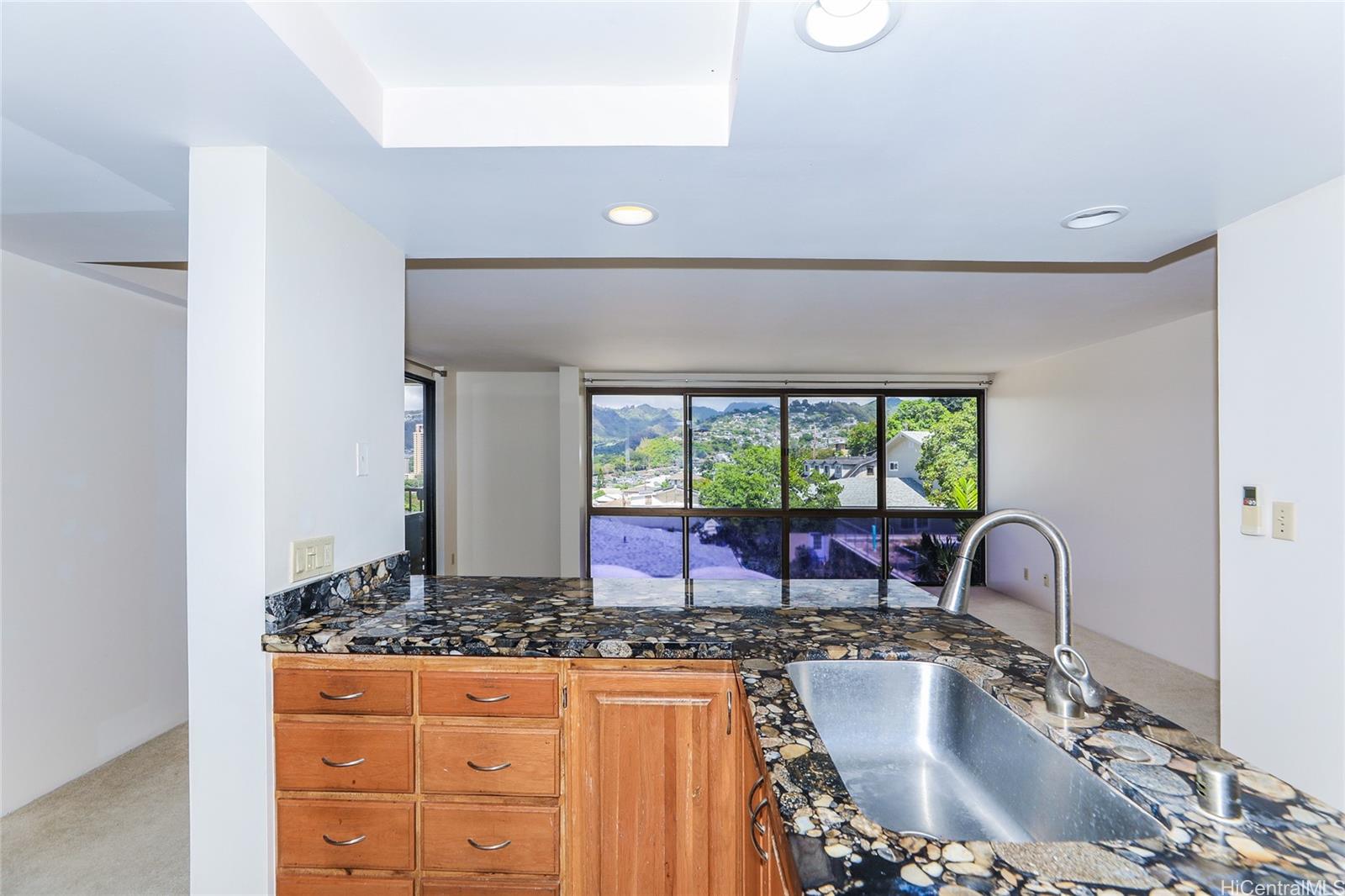 217 Prospect Street, Unit 101 Honolulu, HI 96813 - Photo 10 of 25 a kitchen with a sink and a large window