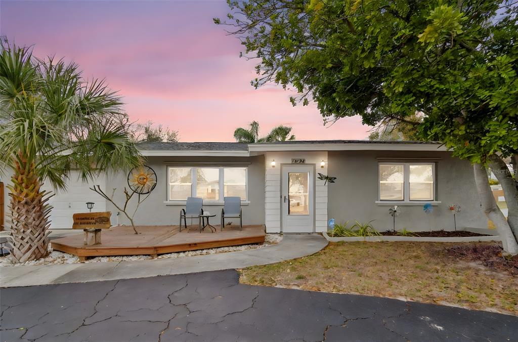 a view of a house with a swimming pool and sitting area