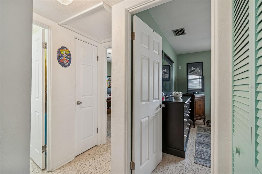 12424 105th Street Largo, FL 33773 - Photo 15 of 45 a hallway with painting on the wall and a large mirror
