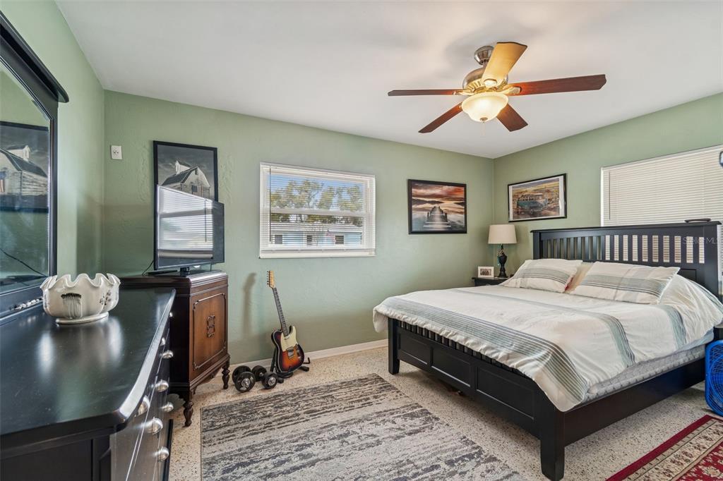 12424 105th Street Largo, FL 33773 - Photo 16 of 45 a bedroom with bed and a chandelier