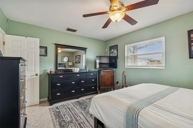 a bedroom with a bed and a dresser