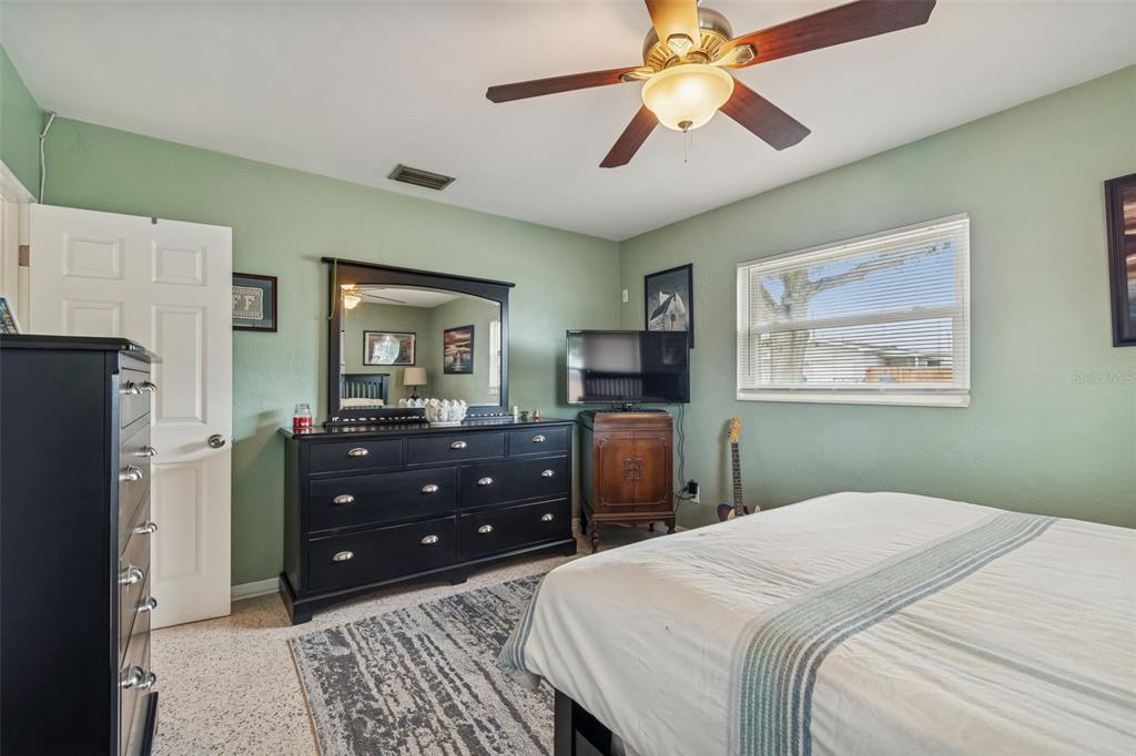 12424 105th Street Largo, FL 33773 - Photo 17 of 45 a bedroom with a bed and a dresser