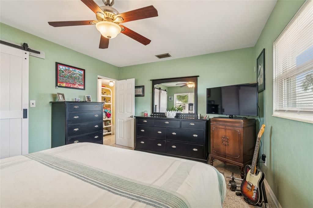 12424 105th Street Largo, FL 33773 - Photo 18 of 45 a bedroom with a bed dresser and a window