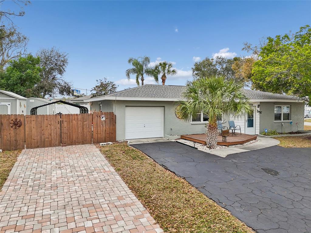 12424 105th Street Largo, FL 33773 - Photo 2 of 45 a front view of a house with a yard and garage