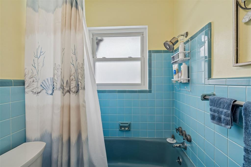 12424 105th Street Largo, FL 33773 - Photo 21 of 45 a bathroom with a shower curtain and a sink