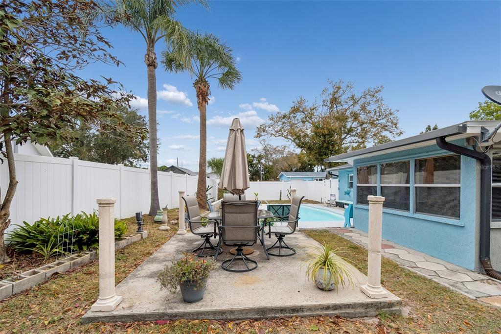 12424 105th Street Largo, FL 33773 - Photo 32 of 45 a view of a patio with couches chairs and potted plants