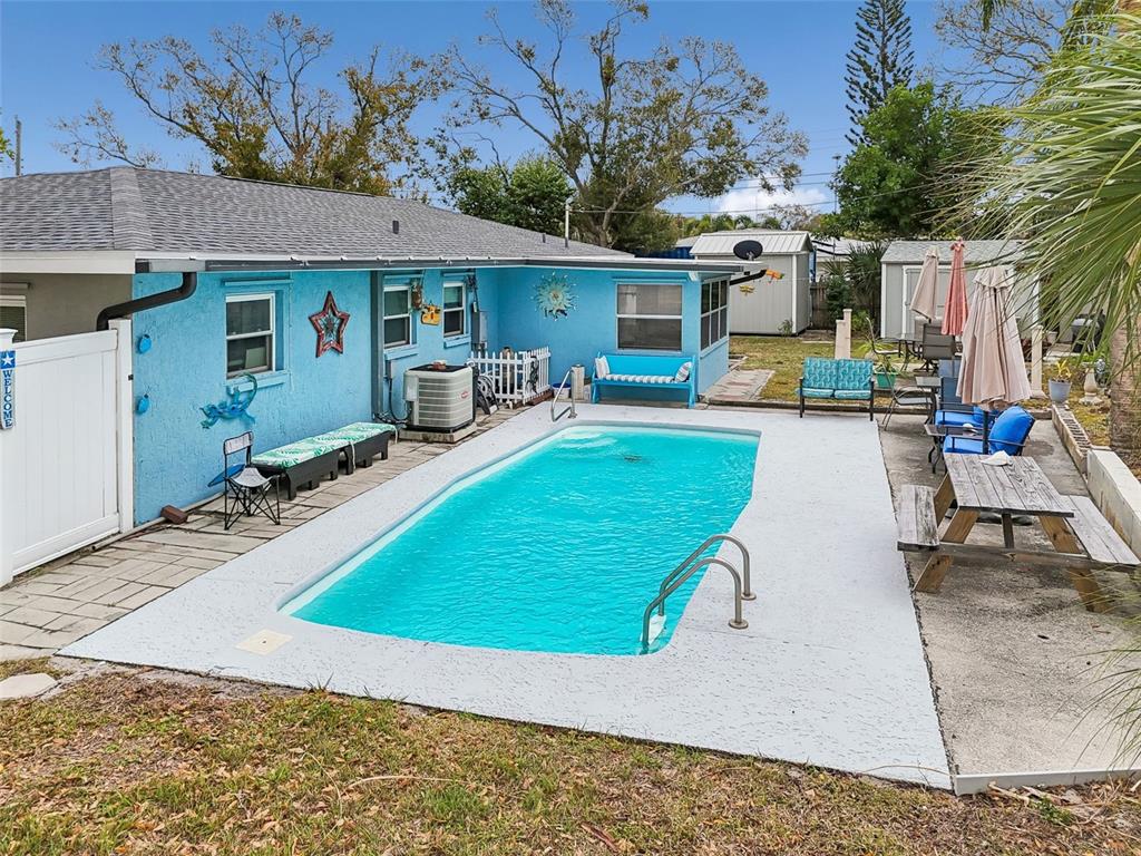 12424 105th Street Largo, FL 33773 - Photo 42 of 45 a view of a house with swimming pool and sitting area