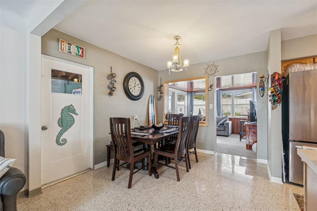 12424 105th Street Largo, FL 33773 - Photo 6 of 45 a view of a dining room and kitchen with furniture and chandelier