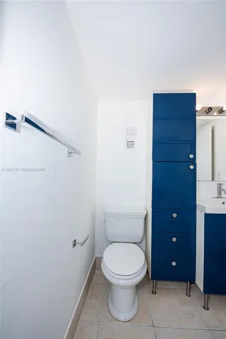 a bathroom with a toilet a sink and vanity