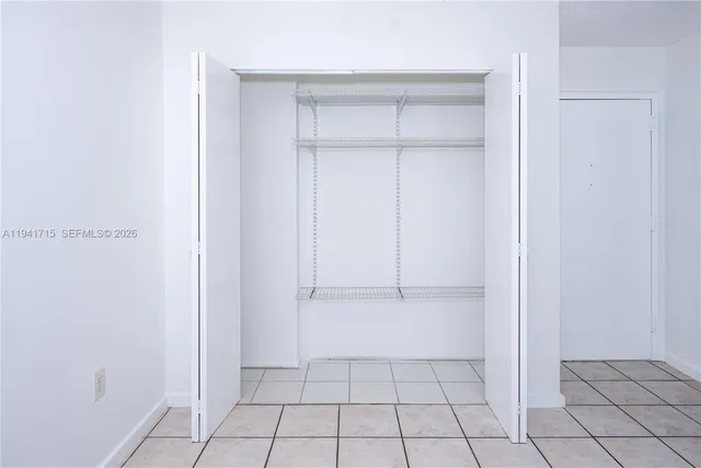a view of an empty walk in closet with entryway
