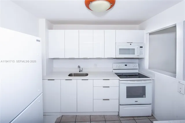 a kitchen with cabinets appliances and a sink