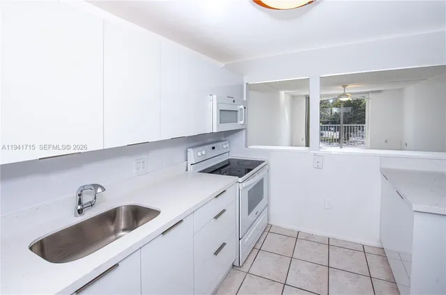 a kitchen that has a sink and a stove
