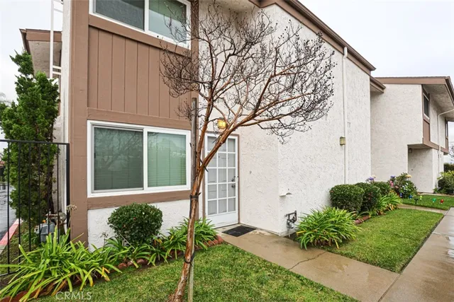 a front view of a house with garden