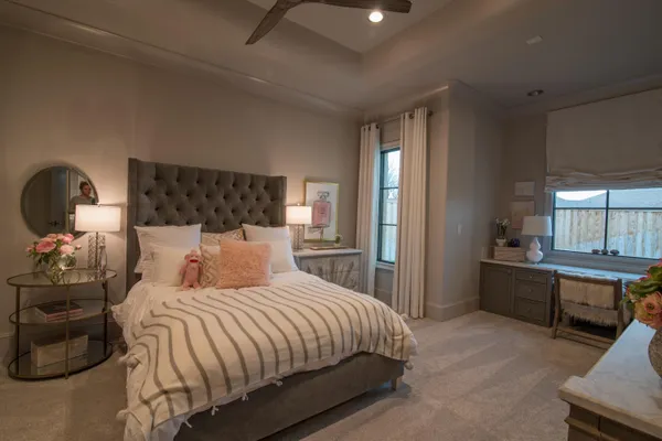 a bedroom with furniture and a large window