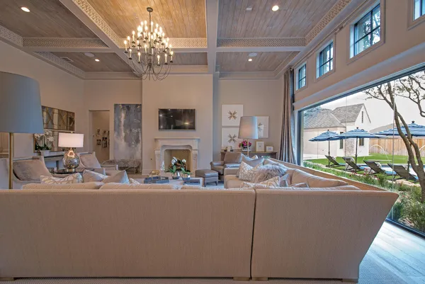 a living room with fireplace furniture and a chandelier