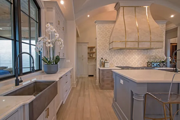 a kitchen with kitchen island granite countertop a sink stainless steel appliances and cabinets