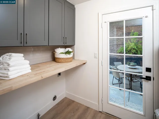 a backyard of a house with fire pit and chairs