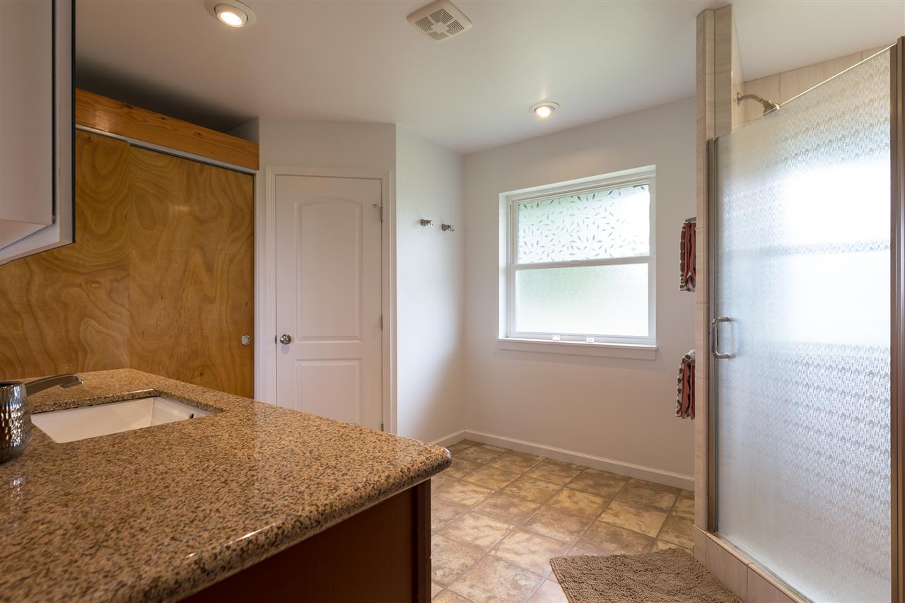 890 East Kuiaha Road Haiku, HI 96708 - Photo 24 of 30 a bathroom with a granite countertop sink and a mirror