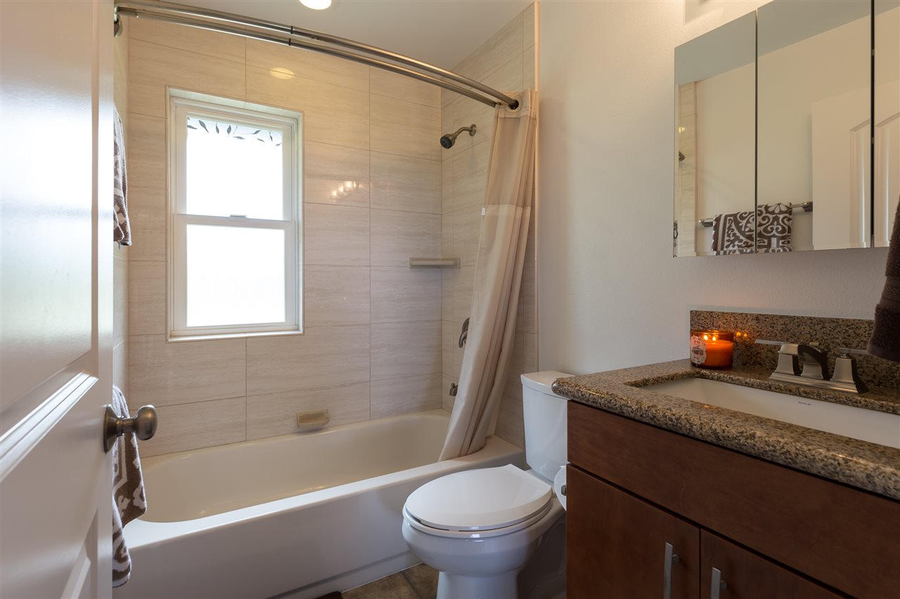 890 East Kuiaha Road Haiku, HI 96708 - Photo 25 of 30 a bathroom with a granite countertop sink a toilet and shower