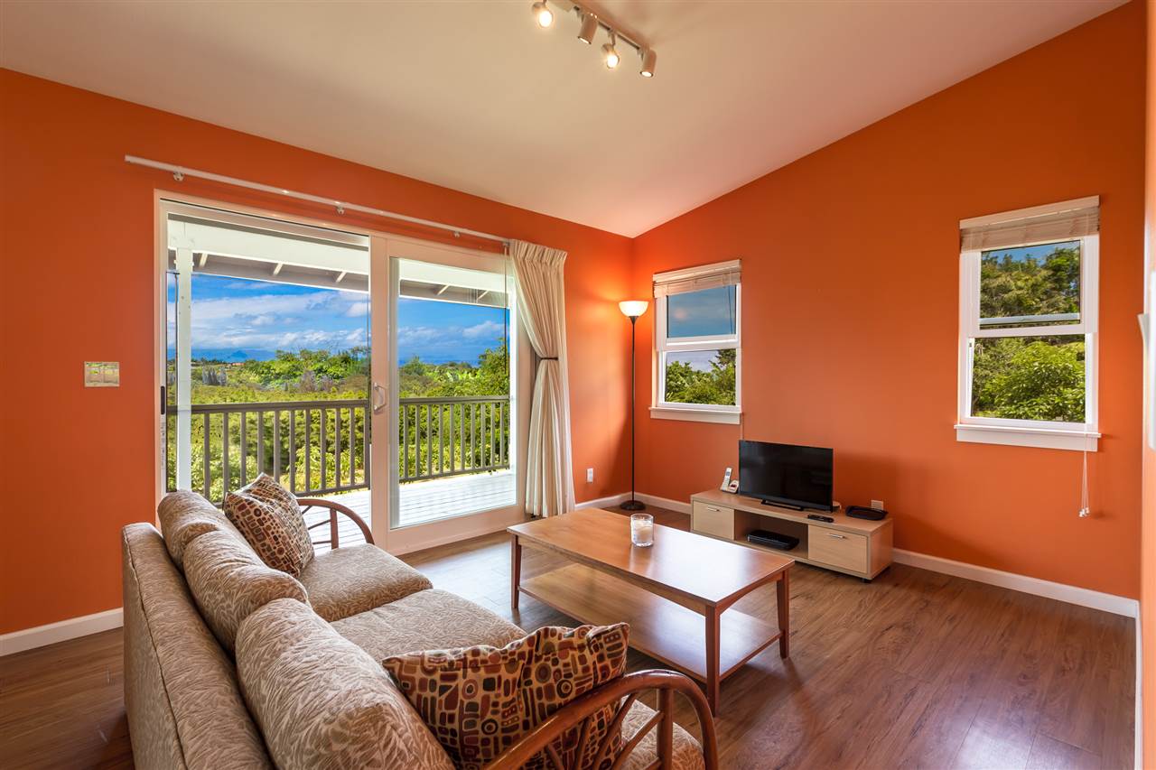 890 East Kuiaha Road Haiku, HI 96708 - Photo 3 of 30 a living room with furniture a table and a large window