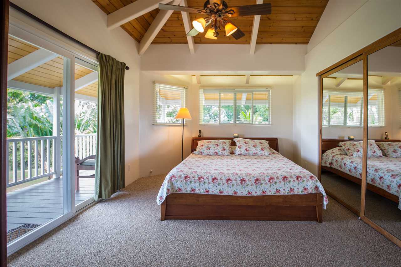 890 East Kuiaha Road Haiku, HI 96708 - Photo 10 of 30 a bedroom with a bed and a chandelier