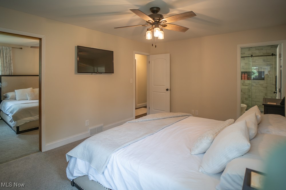 8283 Montello Road Independence, OH 44131 - Photo 4 of 41 Bedroom with LVT floors, ceiling fan, and ensuite bath