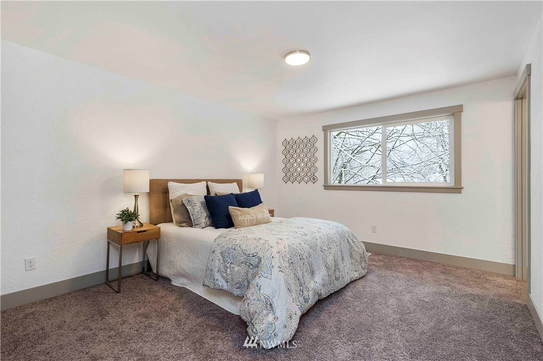 24174 Brier Road Brier, WA 98036 - Photo 15 of 27 a bedroom with a bed and a night stand