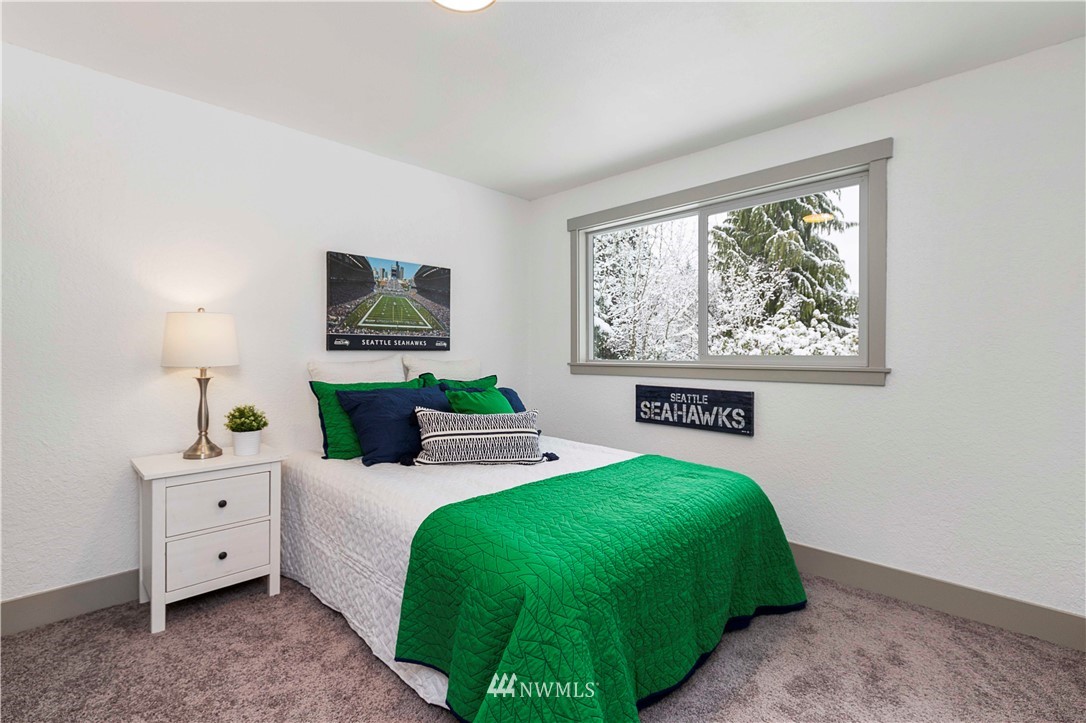 24174 Brier Road Brier, WA 98036 - Photo 18 of 27 a bedroom with a bed and a dresser
