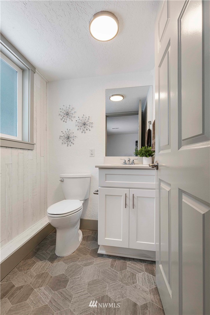 24174 Brier Road Brier, WA 98036 - Photo 22 of 27 a bathroom with a sink toilet and mirror