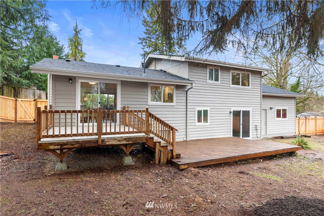24174 Brier Road Brier, WA 98036 - Photo 24 of 27 a view of a house with a wooden deck and furniture