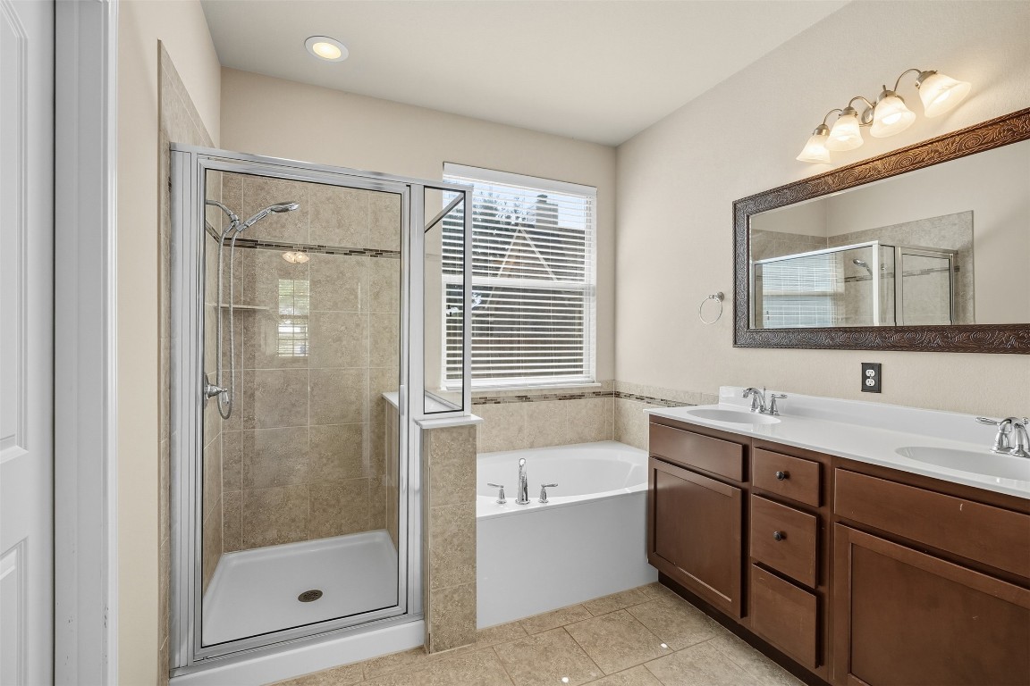 111 Sycamore Street Georgetown, TX 78633 - Photo 10 of 22 a bathroom with a tub sink mirror and shower