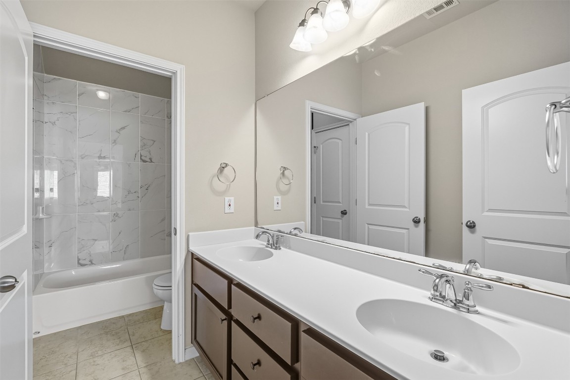 111 Sycamore Street Georgetown, TX 78633 - Photo 15 of 22 a bathroom with a sink double vanity granite tub and shower