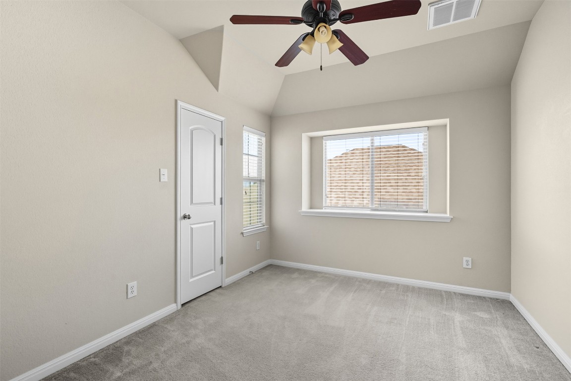 111 Sycamore Street Georgetown, TX 78633 - Photo 16 of 22 an empty room with windows and fan