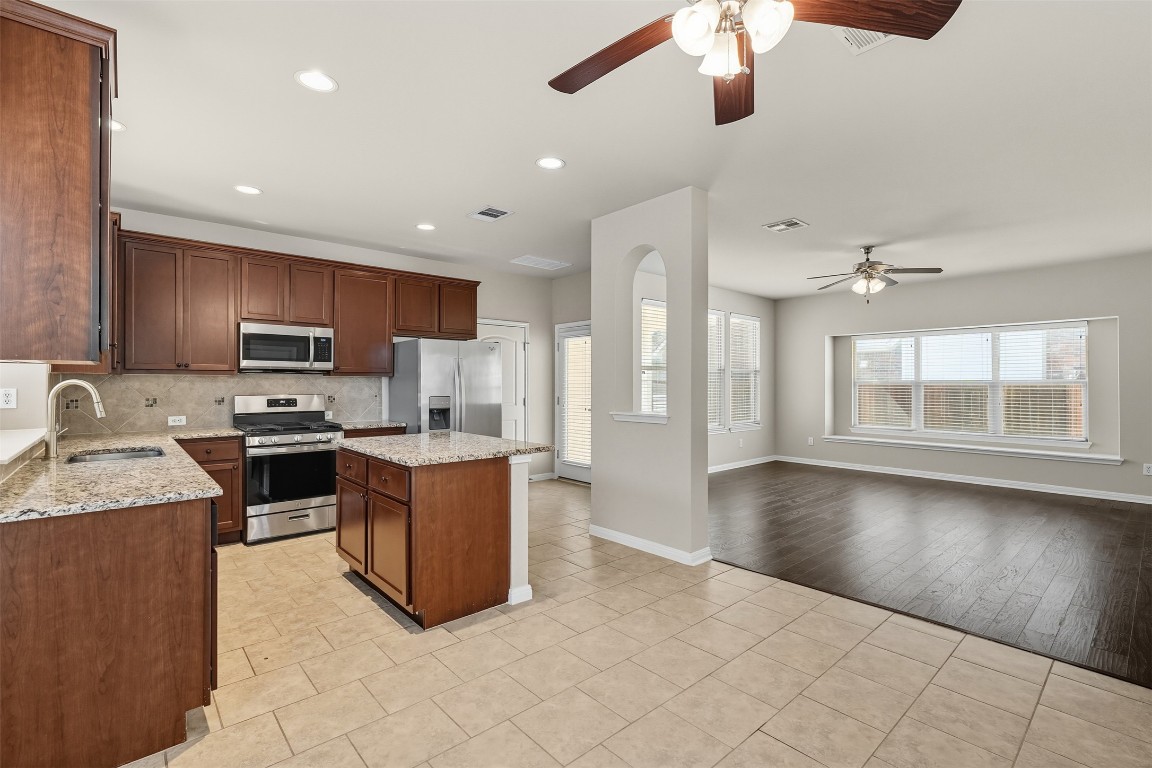 111 Sycamore Street Georgetown, TX 78633 - Photo 7 of 22 a kitchen with a stove a refrigerator and a sink