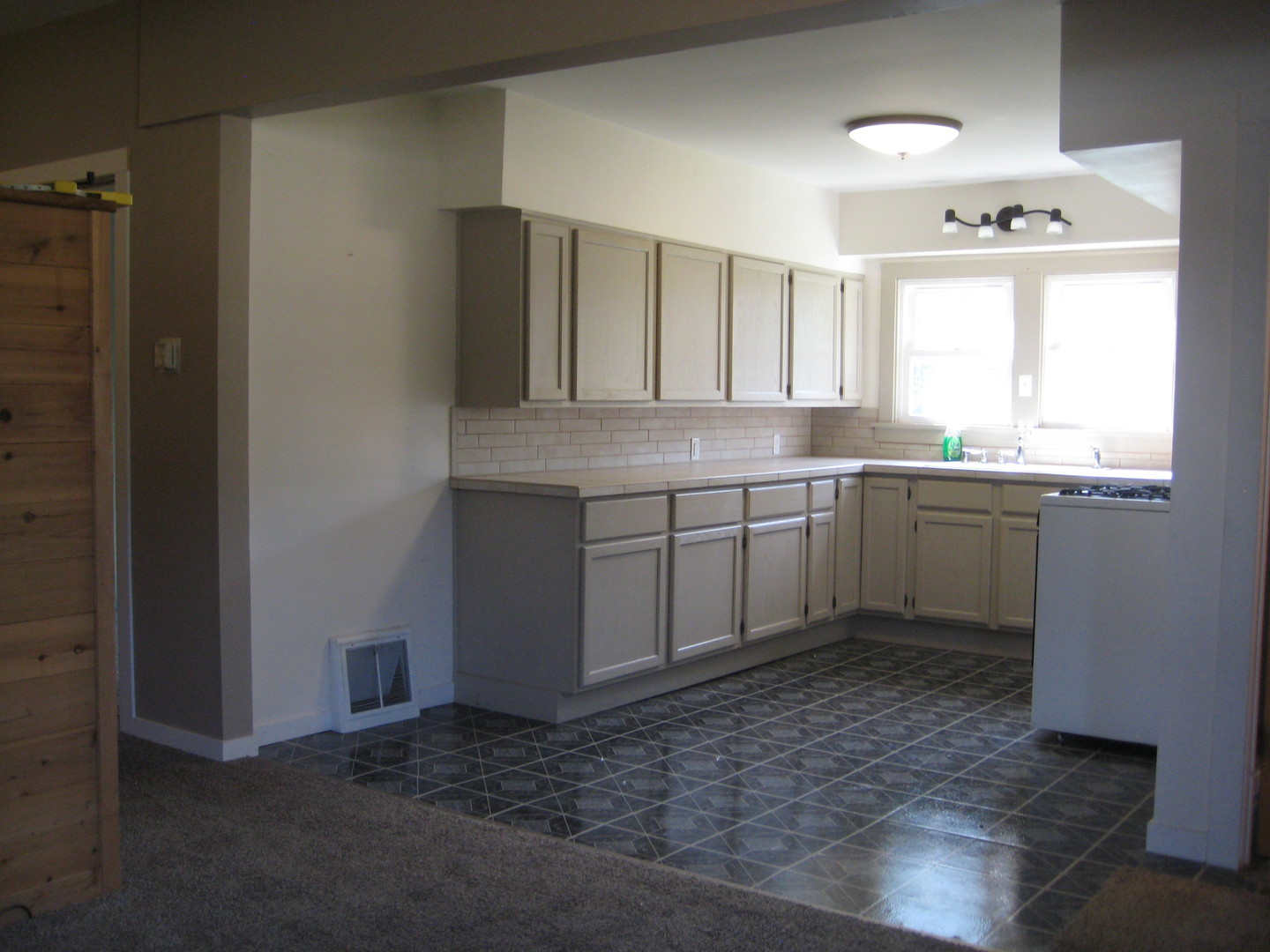 301 South Butler Street Nelson, IL 61021 - Photo 5 of 15 a kitchen with a sink cabinets and window
