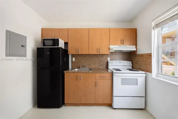 a kitchen with a refrigerator stove and microwave