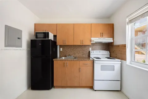 a kitchen with a refrigerator stove and microwave