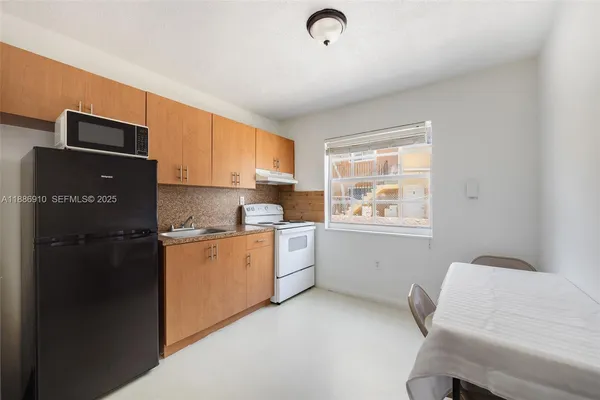 a kitchen with a refrigerator and cabinets