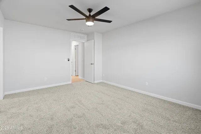 an empty room with a empty space and a ceiling fan