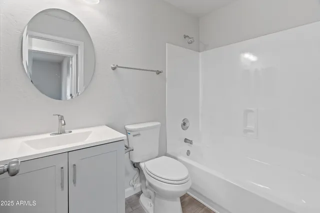 a bathroom with a sink toilet and a mirror