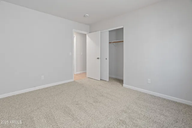 a view of an empty room and closet area