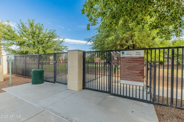 a view of a yard with a house in the background