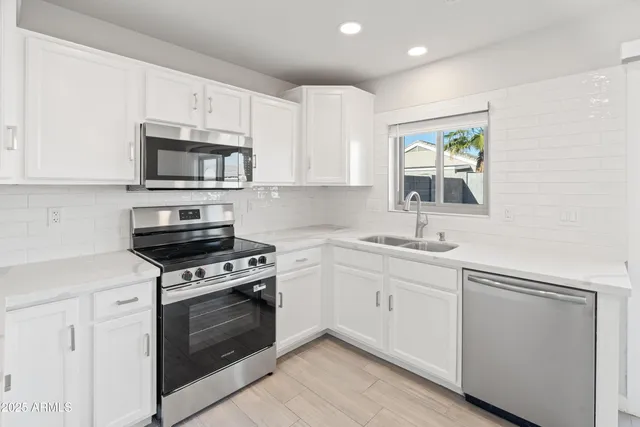 a kitchen with cabinets stainless steel appliances and wooden cabinets