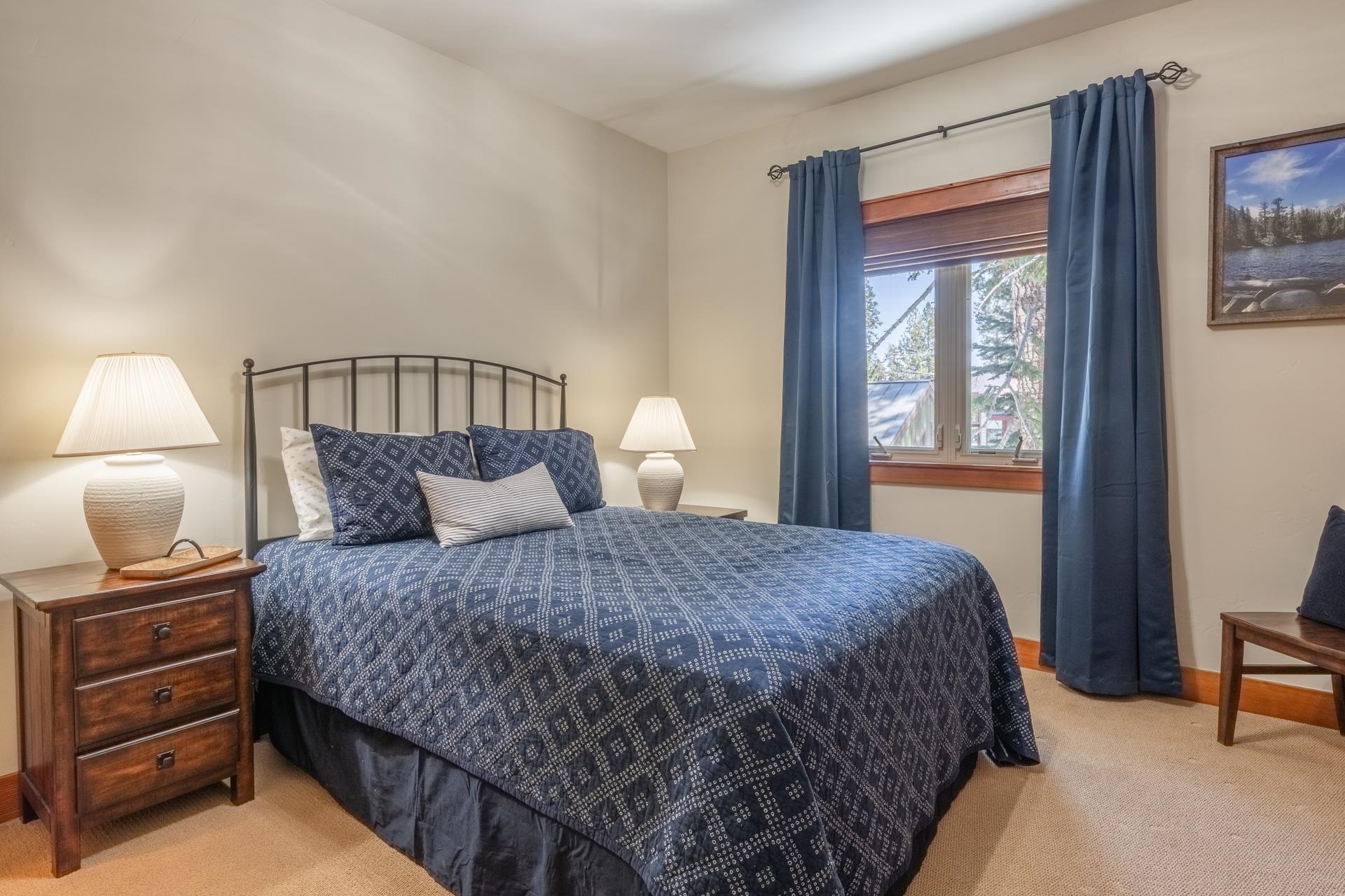 125 Davison Road, Unit 1 Mammoth Lakes, CA 93546 - Photo 25 of 46 a bedroom with a bed and a lamp on dresser