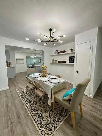 a living room with dining table and wooden floor