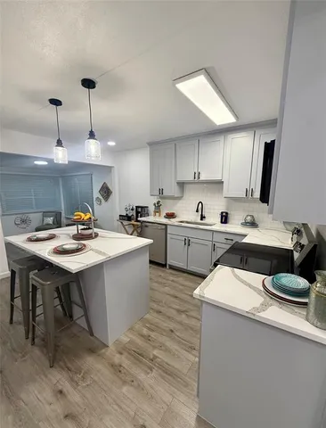 a kitchen with a sink a counter top space and appliances