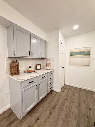 a kitchen with granite countertop white cabinets and white appliances