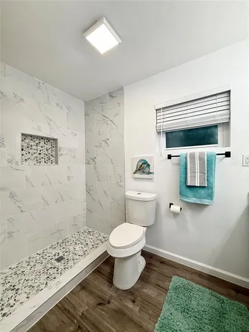 a bathroom with a toilet and a shower