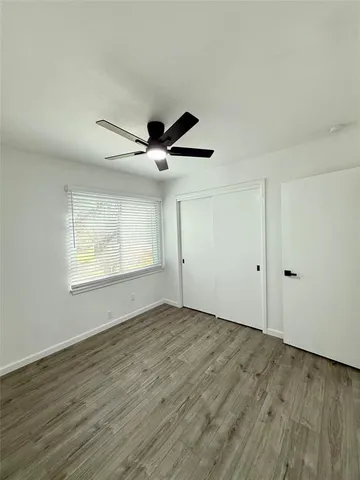 a view of an empty room and wooden floor